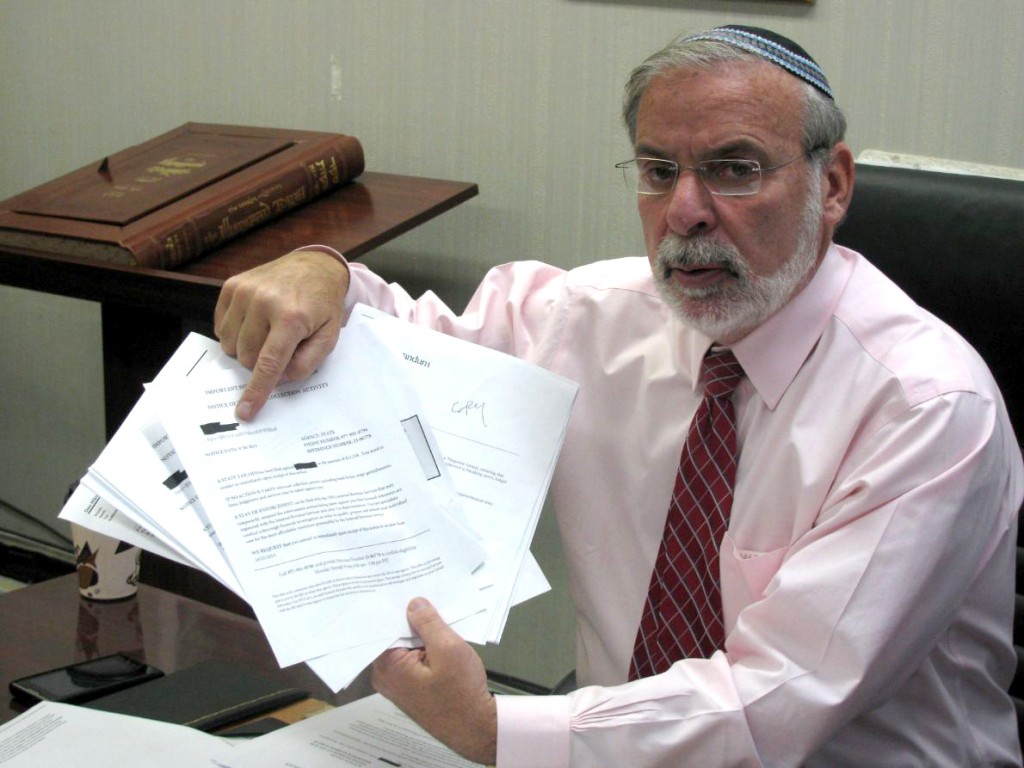 Assemblyman Hikind shows the types of predatory letters that his constituents have received.